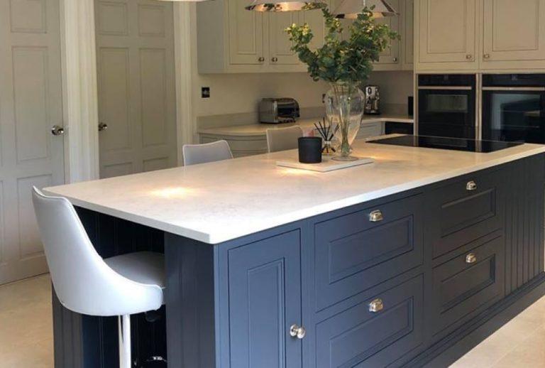 Carrara Marble quartz worktop on a dark blue shaker kitchen installed in Astley Manchester