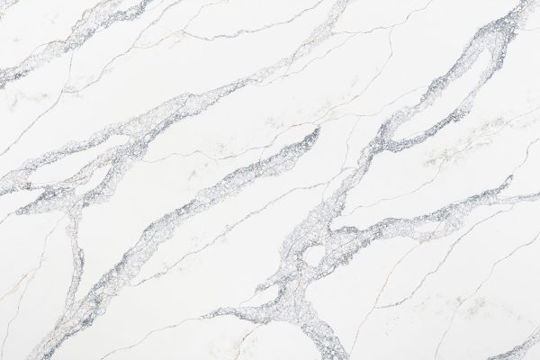 Calacatta marble-inspired quartz, featuring a bright white background with bold, dynamic blue, brown and rust veining